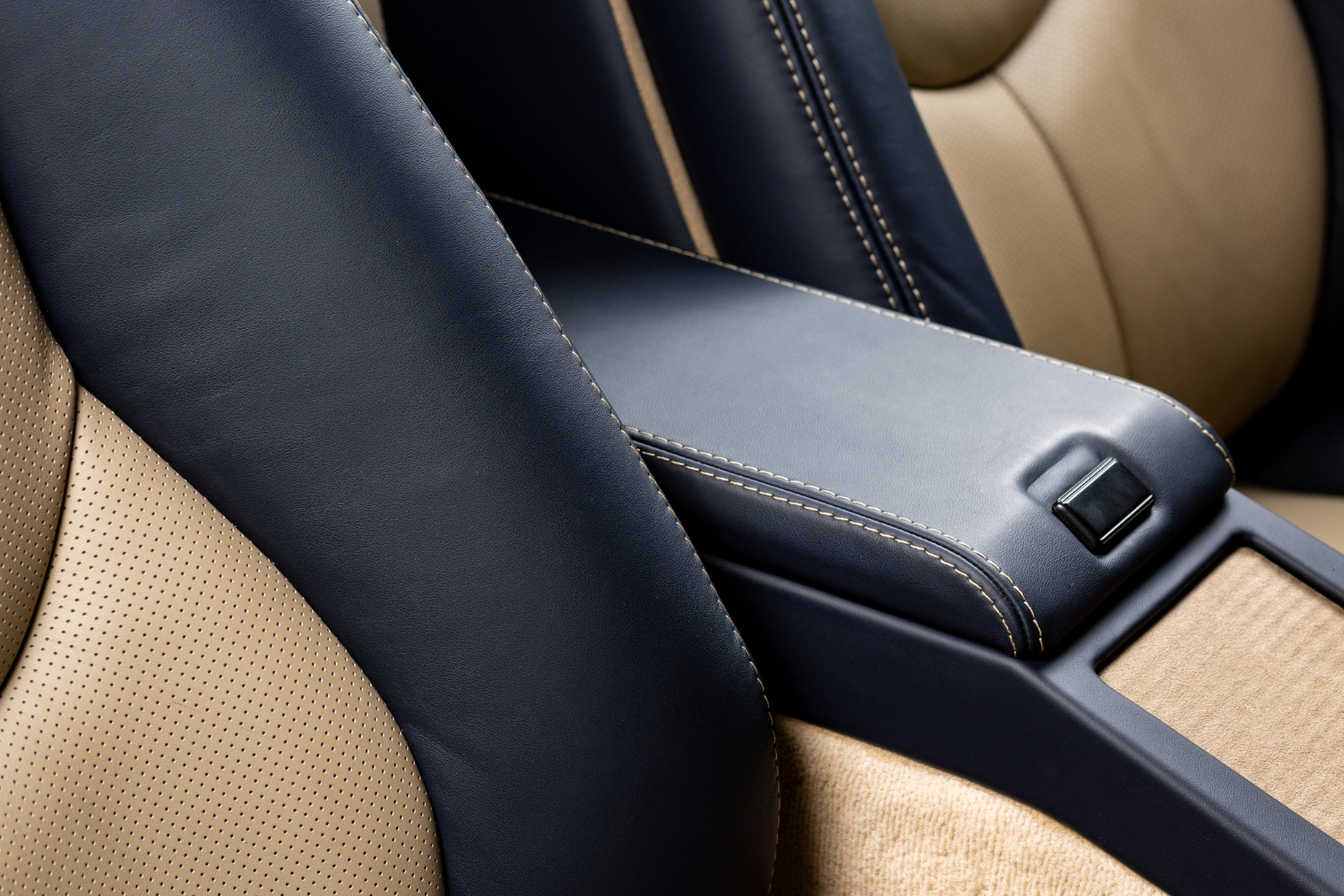 Navy and tan perforated leather car seat with precision stitching